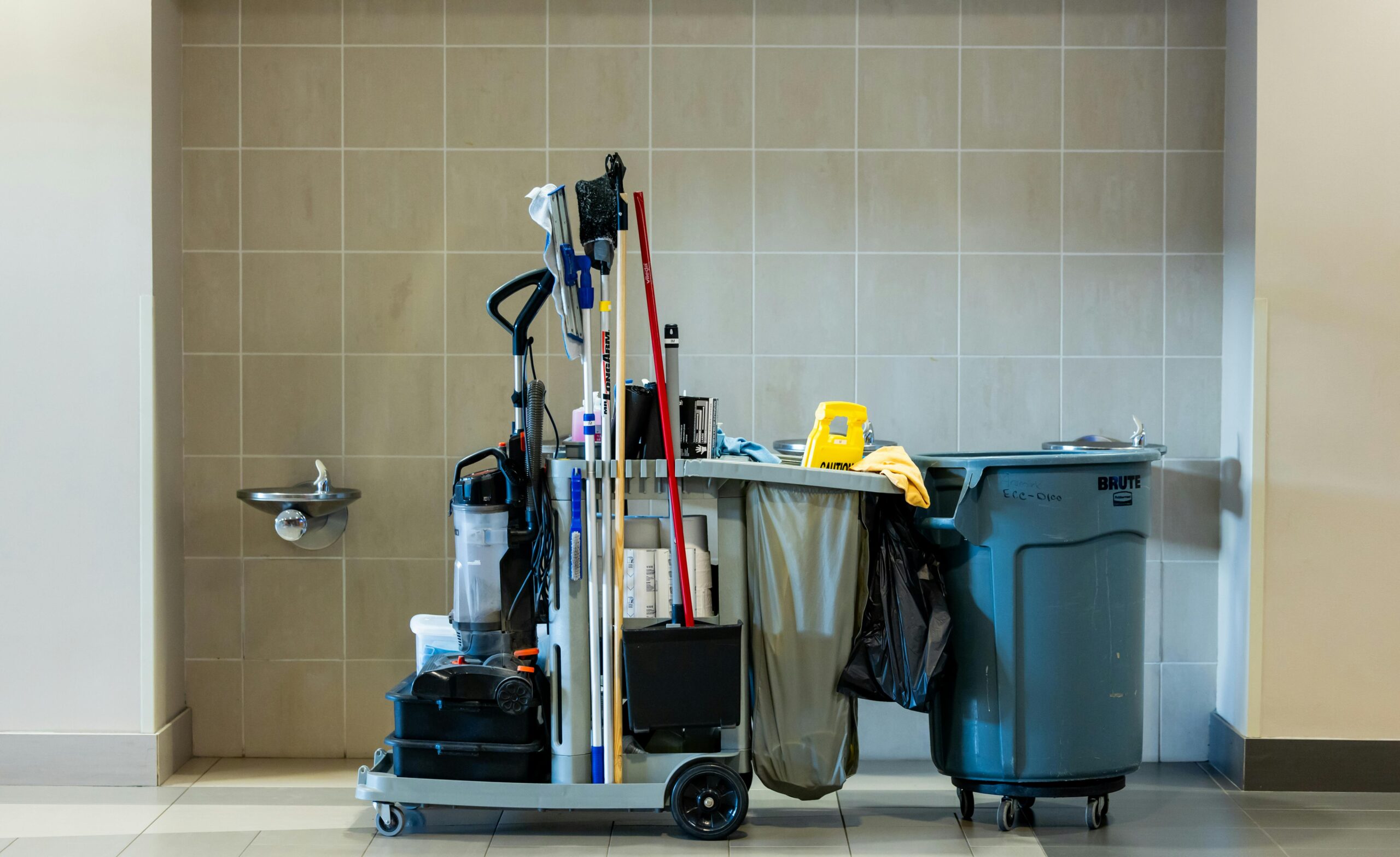 Services A comprehensive collection of professional cleaning tools on a cart in an indoor environment.